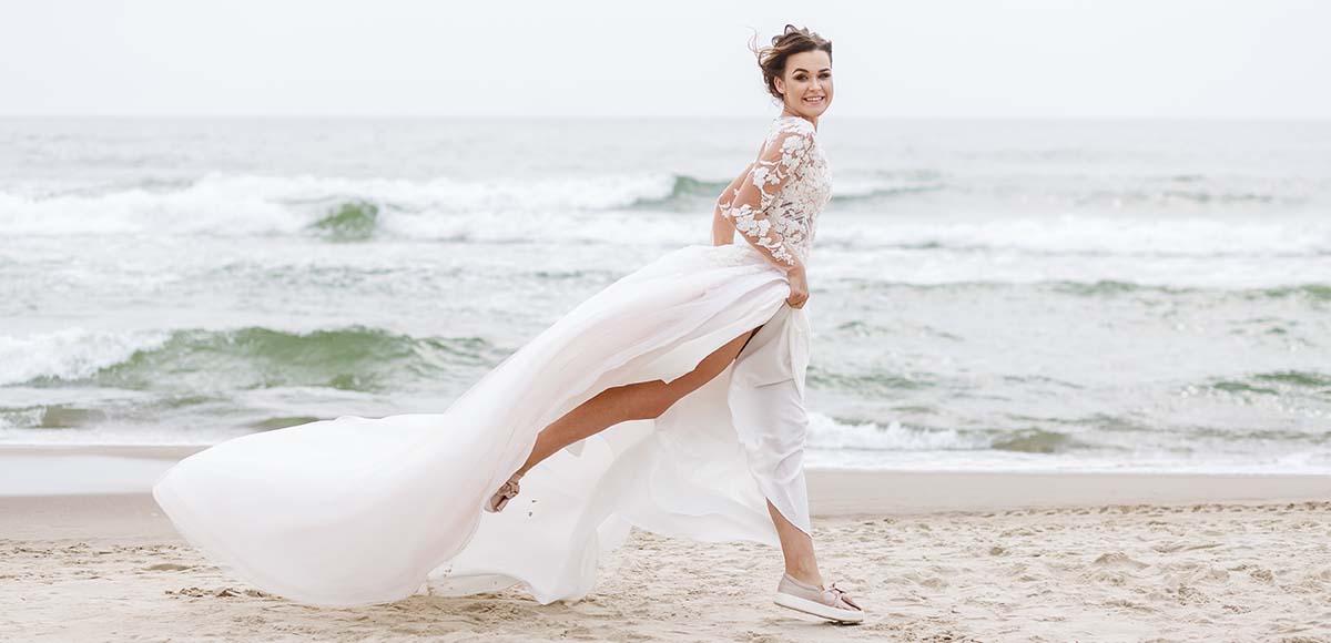 bride runs along the sea beach Koh Lanta wedding